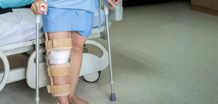 senior woman on crutches because of her hurting knee