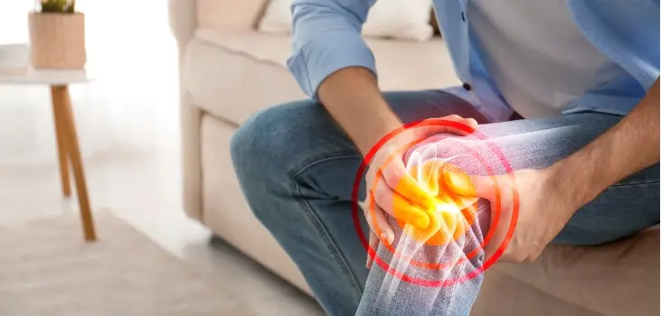 man holding his aching knee
